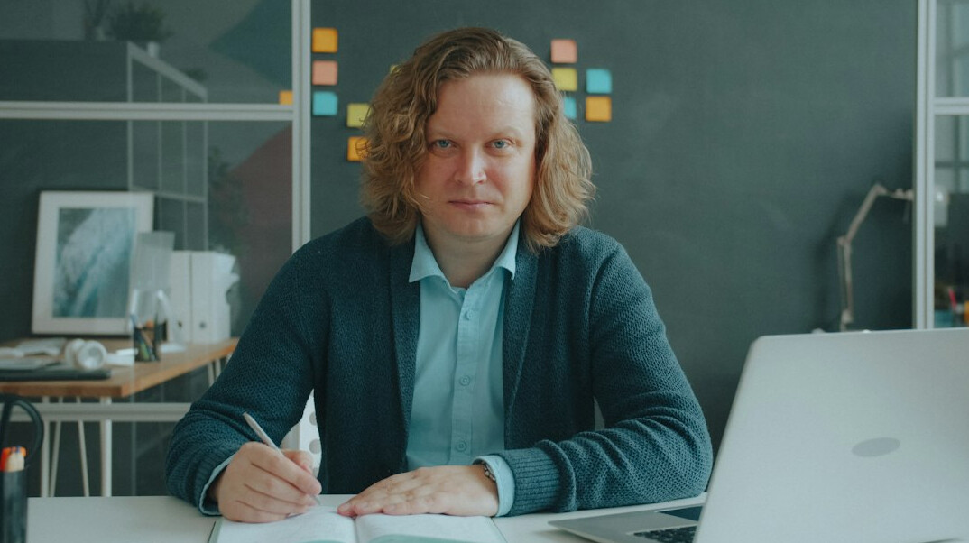 Portrait of a male journalist with a notebook